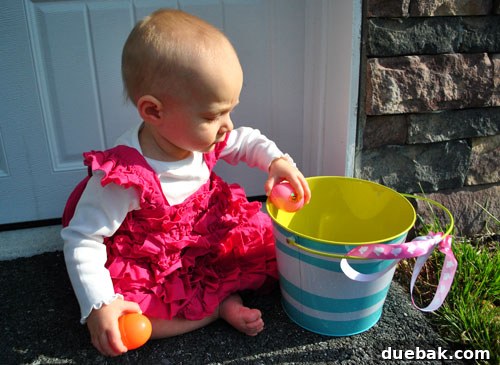 Easter Steals 8 Clara carefully placing a collected Easter egg into her bucket, one egg still in hand