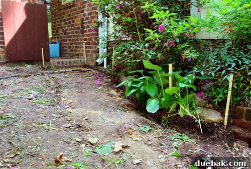 Achieving a Flawless Foundation for Your Paver Patio 11 Wood stakes defining the patio's perimeter for excavation