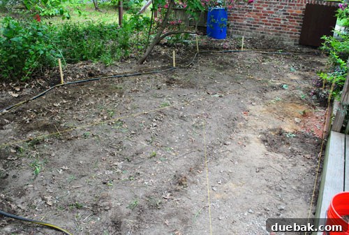 Achieving a Flawless Foundation for Your Paver Patio 14 Completed string layout for patio, showing slope away from house