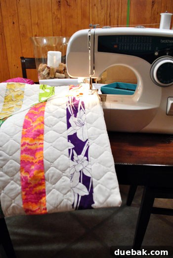 Sewing visible quilting lines down the white strips