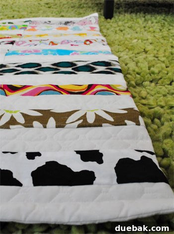 Detail view of the colorful fabric patterns in the quilt