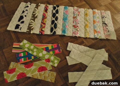 Quilt strips laid out on the floor before sewing