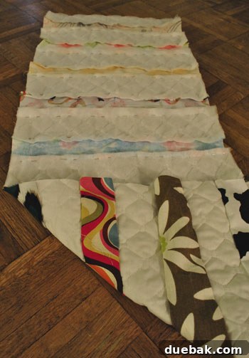 Hand-holding pinned fabric strips ready for sewing
