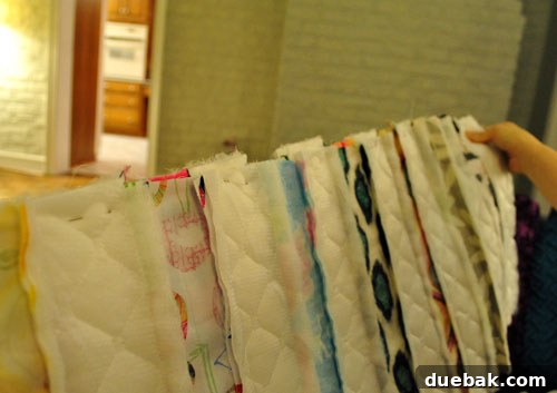 Two quilt rows pinned together for sewing, showing the back side