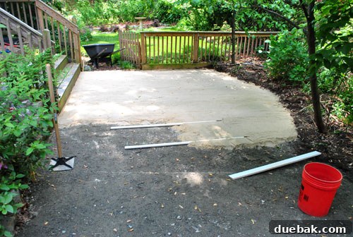 Half-completed sand bedding layer for the patio, showing the smooth, level surface