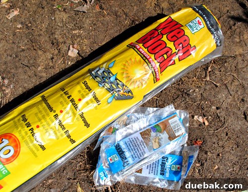 Roll of weed block fabric and ground staples, essential for patio construction