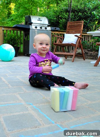 DIY Paver Patio: Transform Your Backyard 26 Clara playing with chalk on patio