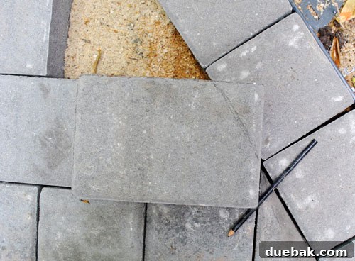 DIY Paver Patio: Transform Your Backyard 5 Marking pavers for cutting