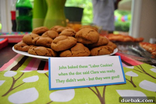 Cinnamon 'Labor Cookies' on a table with a card explaining their humorous story.