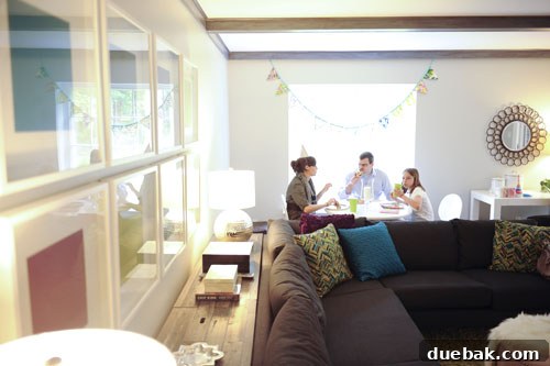 Guests enjoying the party both inside and outside on the sunny patio.
