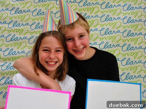 Guests posing in front of a custom fabric backdrop, intended for a photo album for Clara.