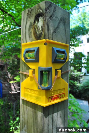 Crafting Your Perfect Property Border 11 Close-up of a post level attached to a fence post, indicating perfect vertical alignment
