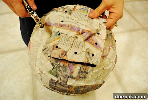Craft Your Own Pull String Piñata 12 Punching holes for pull strings around the piñata flap