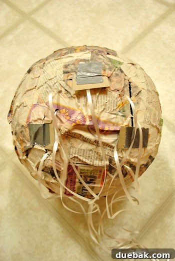 Craft Your Own Pull String Piñata 15 Close-up of the secured treat flap with cardboard tabs
