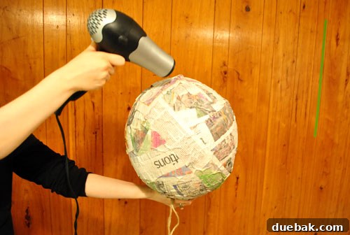 Craft Your Own Pull String Piñata 7 Using a hairdryer to dry the paper mache piñata