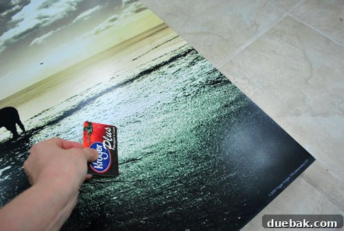 Securely Mounting Large Prints to Canvas Using Acrylic Medium 4 Smoothly adhering the first print to the canvas with spray adhesive