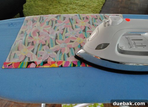 Ironing the short ends of the runner for hemming