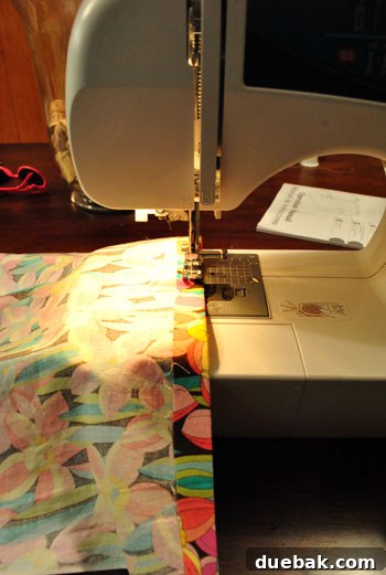 Sewing the ironed hems on the ends of the runner