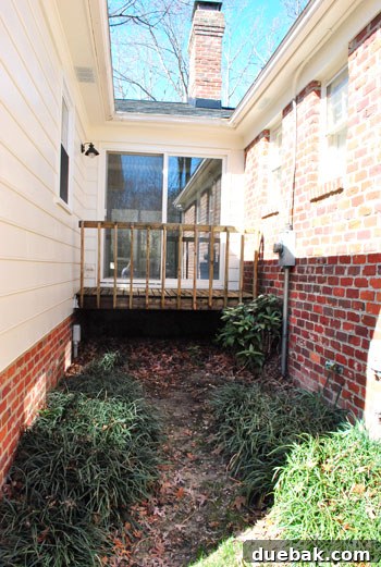 Outdoor Progress: A Guided Tour 3 Narrow alleyway between the original house structure and a rear addition, showcasing the property's unique architectural details