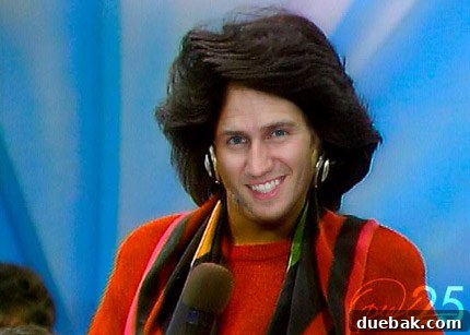 Humorous Oprah-fied image of John (the author's husband) with big hair and oversized earrings