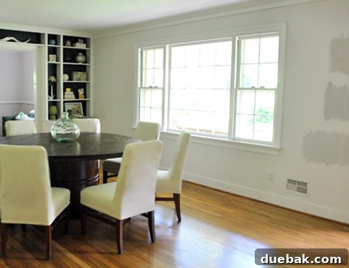 Moonshine by Benjamin Moore: The Serene Light Gray You've Been Searching For 4 Before painting: A dining room wall with visible test paint swatches, showing the previous light color and potential for a soft gray transformation.