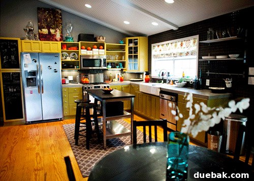Kelly Moore's charming kitchen with two-tone cabinets and concrete countertops