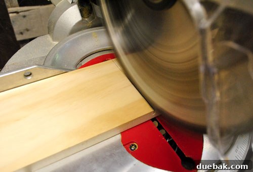 Cutting the craft wood with a miter saw in a workshop