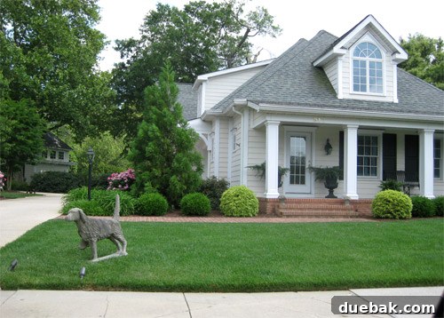 A house in Lewes, Delaware, featuring a large concrete dog statue guarding the front yard, adding unique character.