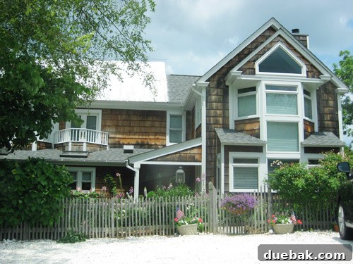A picturesque beach house in Lewes with crisp white trim and a classic picket fence, exuding coastal elegance.