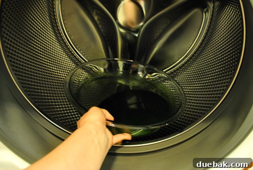 Pouring dye mixture into the front-loading washing machine