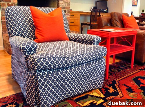 Inside a Stunning North Carolina Home 12 Family room details: a patterned inherited rug, a DIY recovered navy geometric chair, and a lacquered red side table