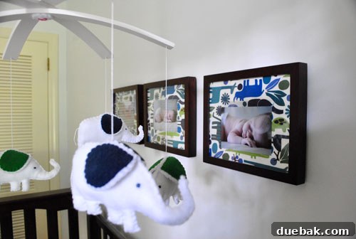 Inside a Stunning North Carolina Home 16 Adorable felt mobile and framed baby photos with coordinating animal fabric mats above Davis's crib