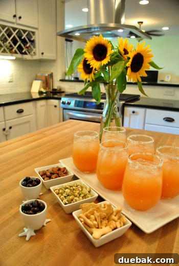 Inside a Stunning North Carolina Home 5 Kitchen island styled with a hospitable spread of snacks and refreshing drinks for guests