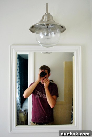 Shedding New Light on Our Bathroom 20 New light fixture with wire cage removed