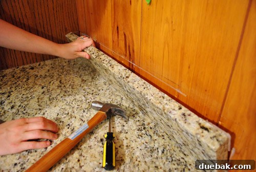 Removing Cabinets and Repairing Vinyl Flooring 15 Removed backsplash section of the desk, revealing the wall behind