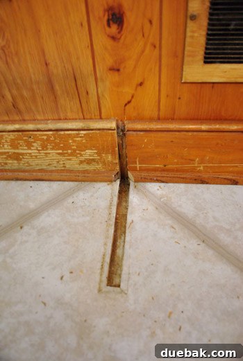 Removing Cabinets and Repairing Vinyl Flooring 19 Hole in the vinyl floor where the desk leg was, revealing layers underneath