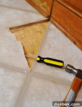 Removing Cabinets and Repairing Vinyl Flooring 20 Scraping up the old, damaged vinyl floor tile