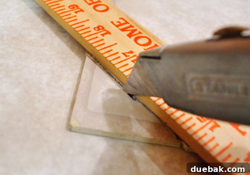 Removing Cabinets and Repairing Vinyl Flooring 22 Measuring and cutting a new vinyl floor tile to fit the gap