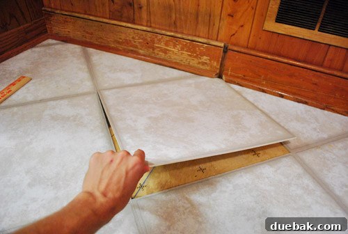 Removing Cabinets and Repairing Vinyl Flooring 23 New vinyl floor tile installed in the gap, relying on old adhesive