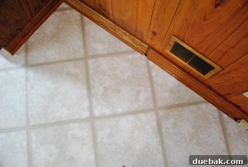 Removing Cabinets and Repairing Vinyl Flooring 24 New vinyl floor tile held down by a car seat to ensure proper adhesion