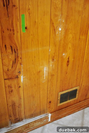 Removing Cabinets and Repairing Vinyl Flooring 25 Repaired baseboard and spackled paneling, ready for paint