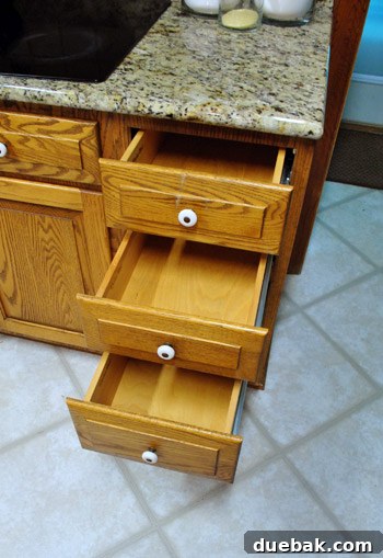 Empty kitchen drawers located near an office area, awaiting organization.