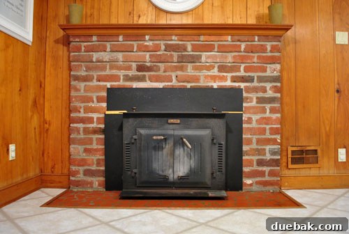 Revamping Our Wood Paneling with Paint 11 Original brick fireplace before any renovation