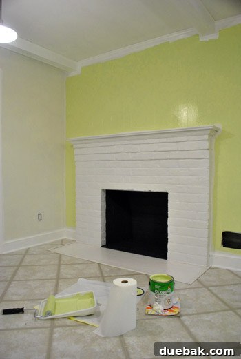 Revamping Our Wood Paneling with Paint 8 Green kitchen wall near fireplace with white trim