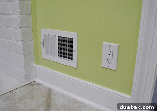 Revamping Our Wood Paneling with Paint 10 New crisp white electrical outlets and vents