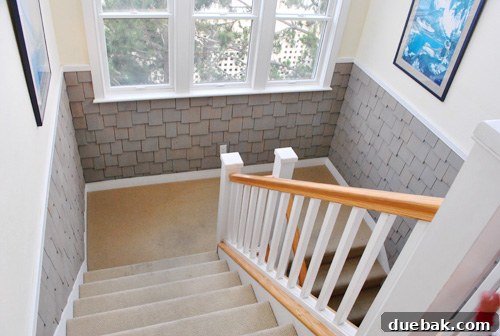 Sun-Drenched Serenity: A Duck Beach Getaway 8 Shaker shingle interior stairwell design