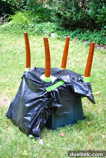 Chair prepared for spray painting with upholstery masked