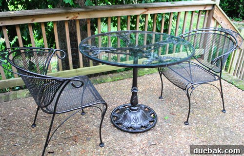 Wide shot of the newly painted patio set in its outdoor setting