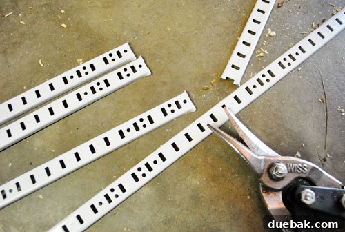 Metal shelf tracks for adjustable shelving