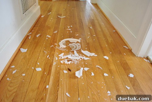 Broken glass from the new light fixture scattered on the floor